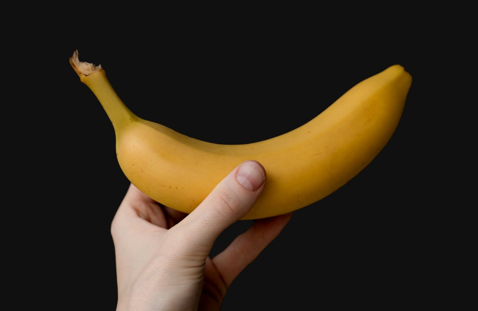 a person holding a banana in their hand